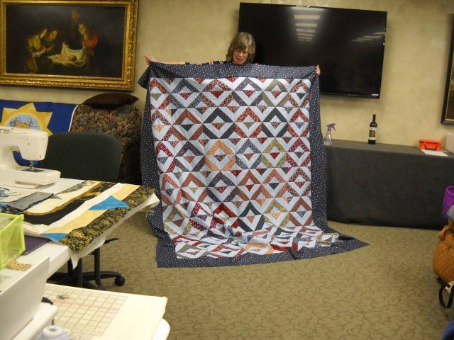 JoAnne-shares-her-Quilt-of-Honor-scaled